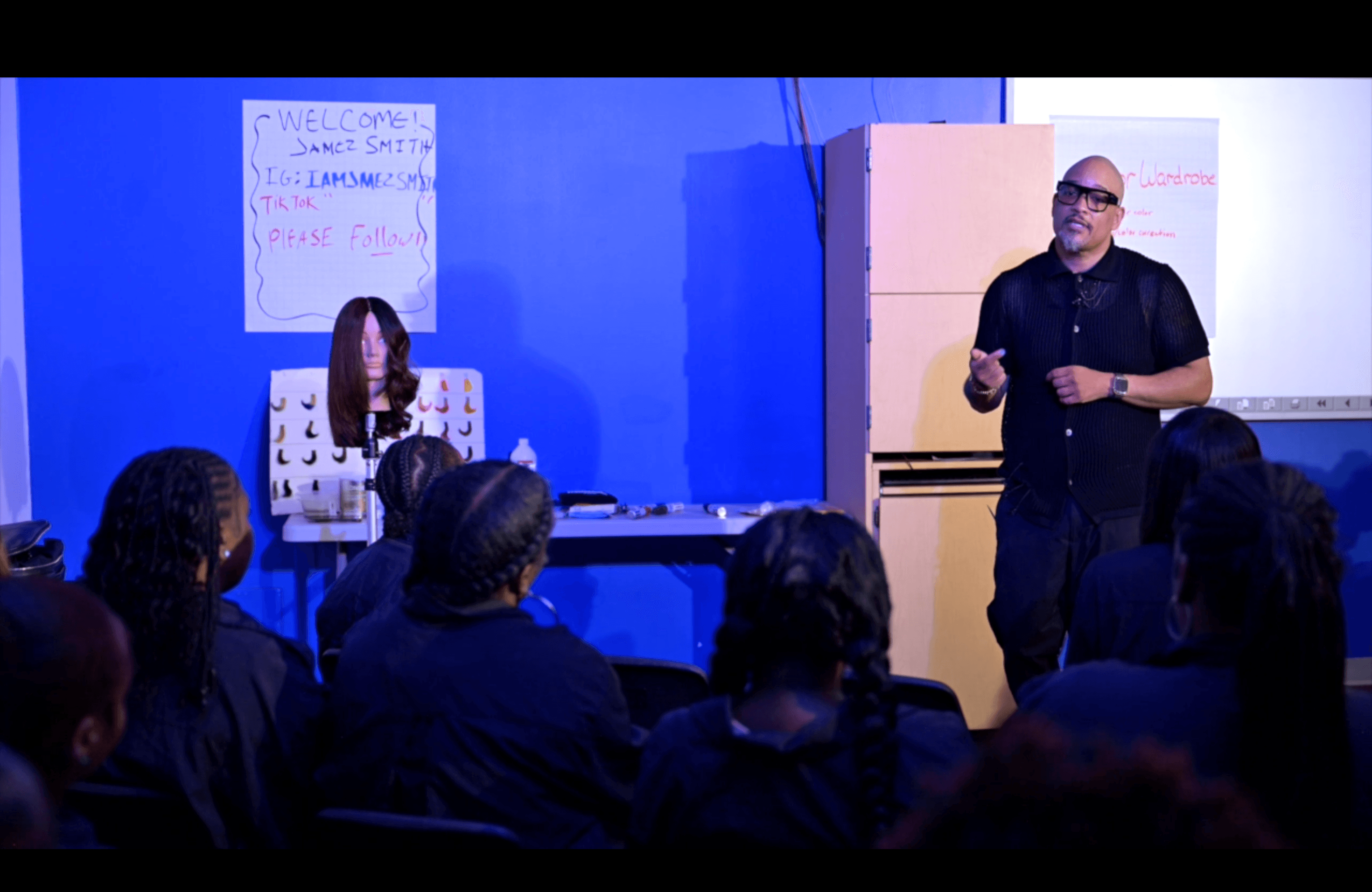 Classroom training session with instructor teaching audience in professional presentation setting